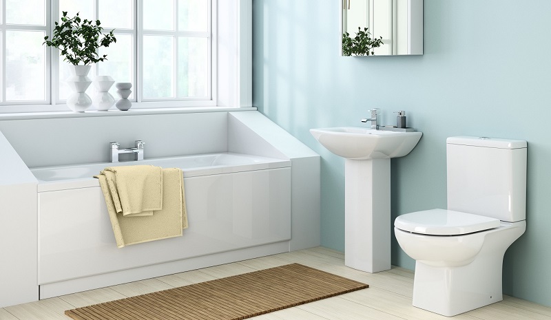 Duck egg blue bathroom with white bath, sink, and toilet