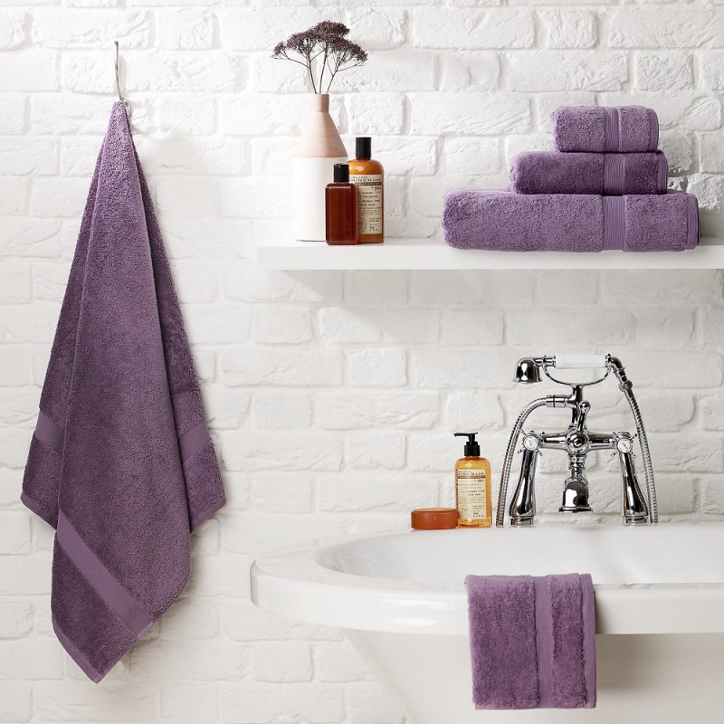 purple towels in white bathroom