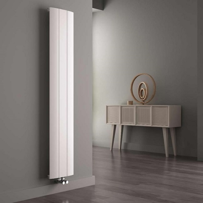 white vertical designer radiator in grey room with natural furniture