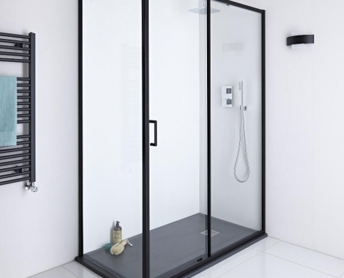 Black framed sliding shower door enclosure with black slate shower tray