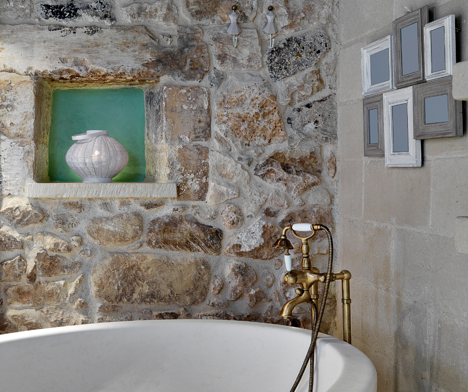 a rustic bath space with freestanding bath tap