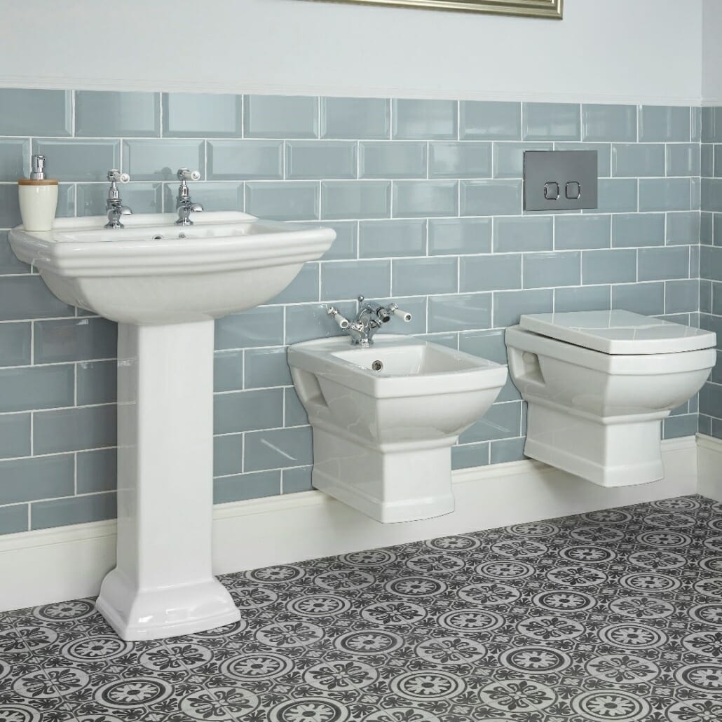 A traditional basin toilet and bidet combination in a traditional country bathroom space