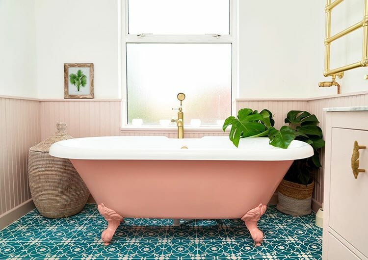A colourful pink bath in a bright colourful scandi bathroom
