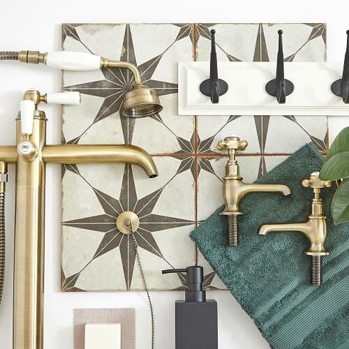 Scandi bathroom moodboard showing black and gold brassware on a tiled background