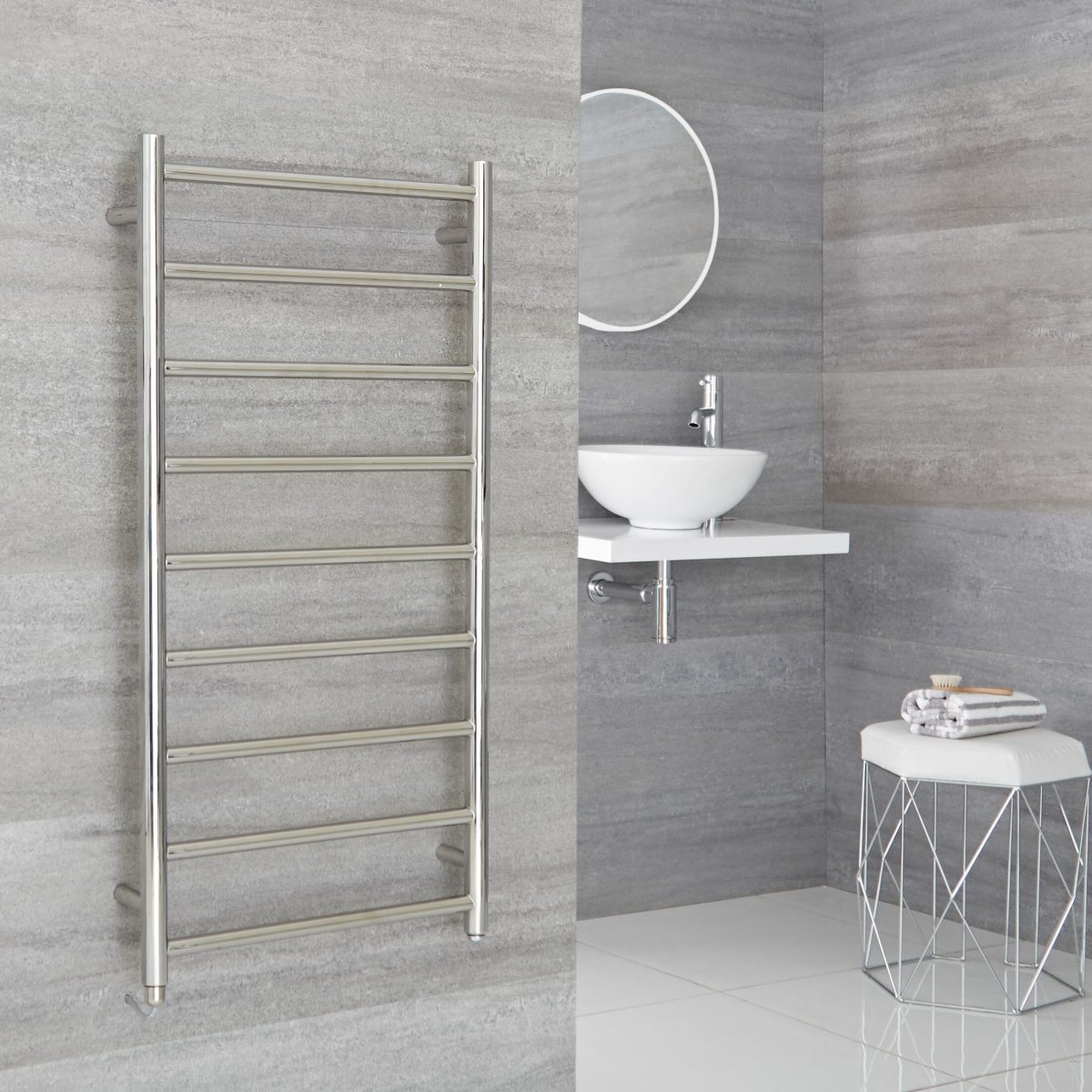 a large chrome heated towel rail in a bathroom space