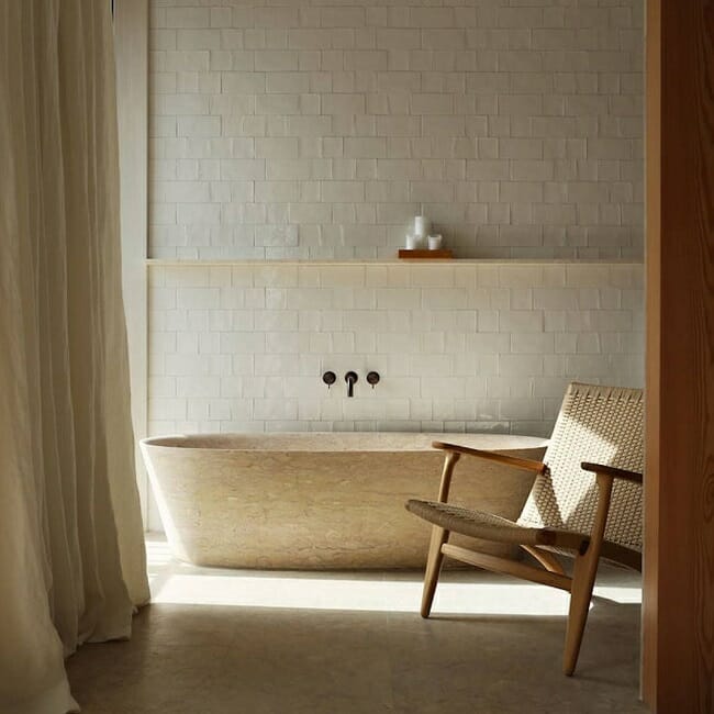 hans wegner chair in a scandinavian style bathroom