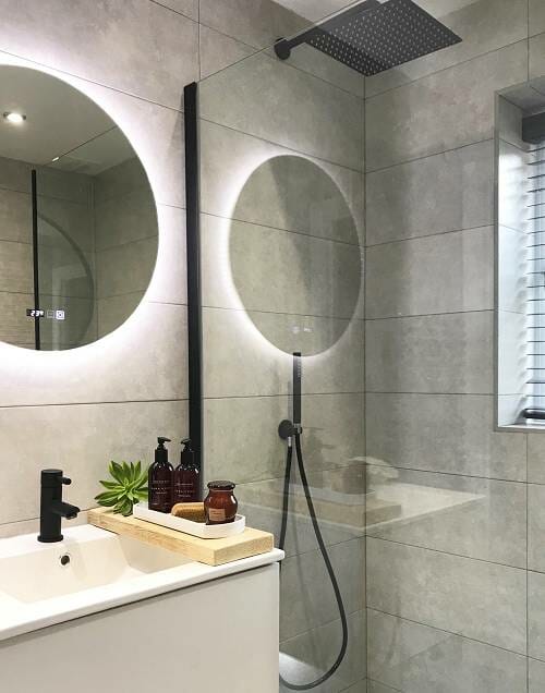 a scandi bathroom with a black shower and brassware finish