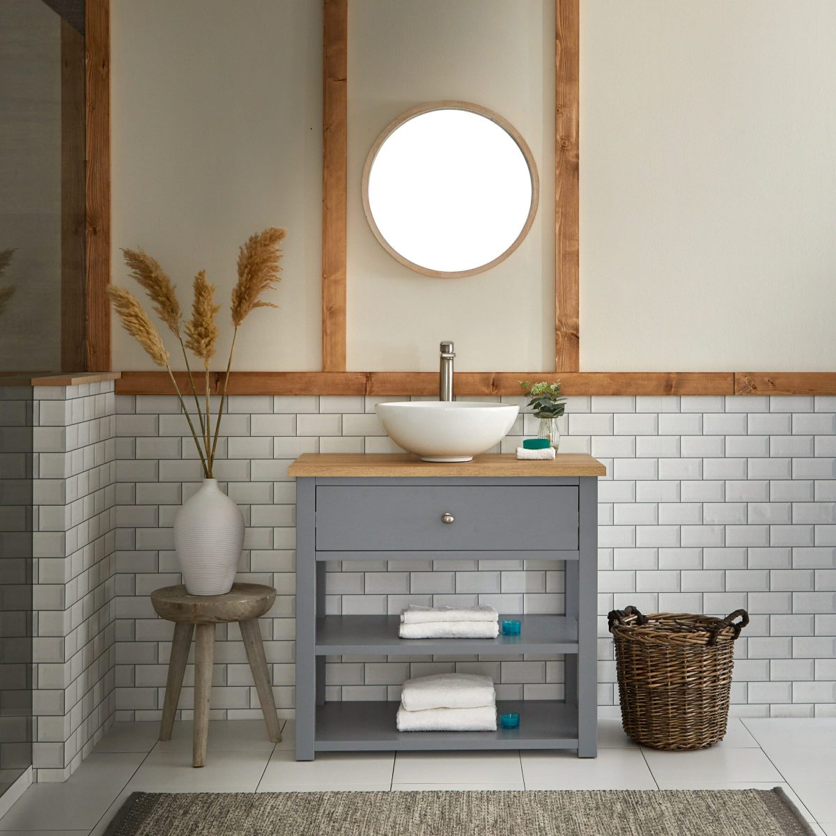 A vanity unit basin area in a white tiled bathroom space