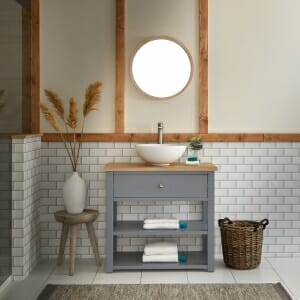 A vanity unit basin area in a white tiled bathroom space