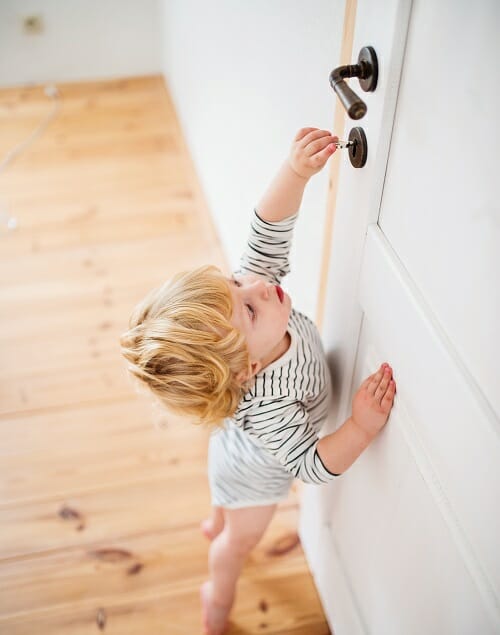 toddler opening a bathroom door