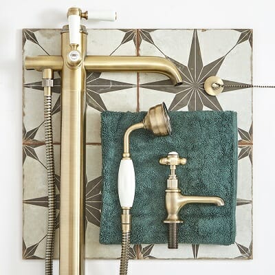 a flat lay moodboard with gold brassware and taps
