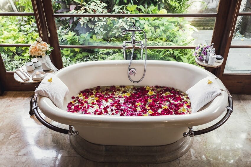 Traditional bathtub filled with flower petals