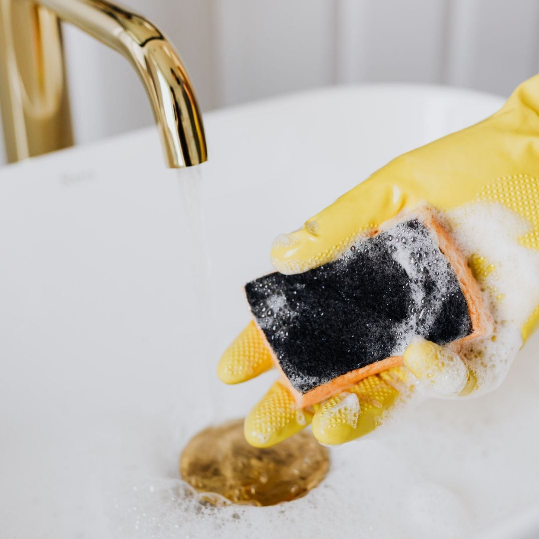 Bathroom brassware being cleaned to a shine