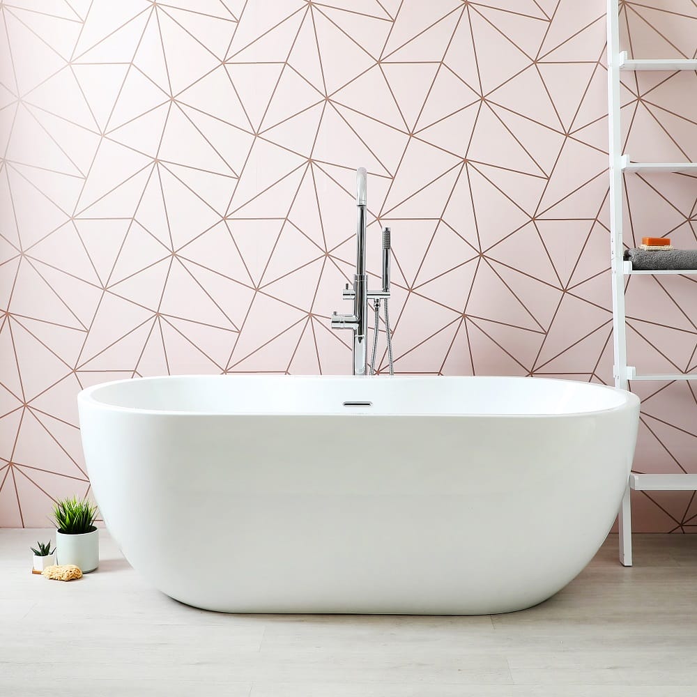 a freestanding bath against a bold pink coloured wall