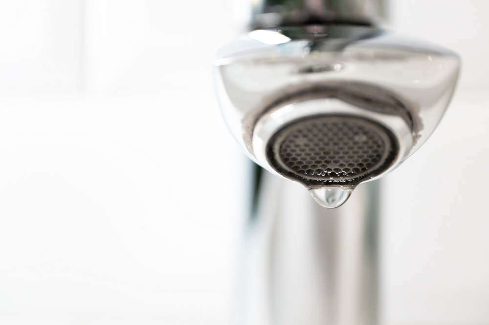 close up of a dripping chrome tap