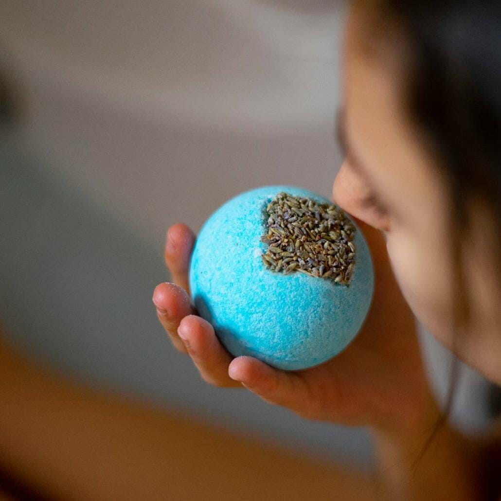 lady smelling blue scented bath bomb