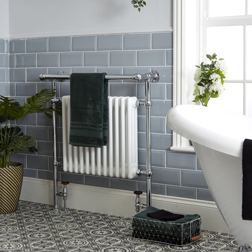 traditional bathroom towel rail with green towel draped over it